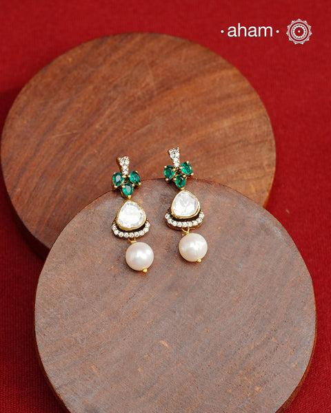 Expertly crafted studs in 92.5% sterling silver with a fine gold polish finish and elegantly set with brilliant moissanite stones and lustrous green stones. Designed to offer lasting shine and sophistication making them a perfect choice for special occasions.