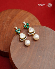 Expertly crafted studs in 92.5% sterling silver with a fine gold polish finish and elegantly set with brilliant moissanite stones and lustrous green stones. Designed to offer lasting shine and sophistication making them a perfect choice for special occasions.