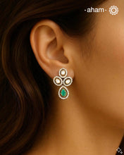 Expertly crafted earrings in 92.5% sterling silver with a fine gold polish finish, elegantly set with brilliant moissanite stones and a lustrous green stone in the center. Designed to offer lasting shine and sophistication making them a perfect choice for special occasions. &nbsp;