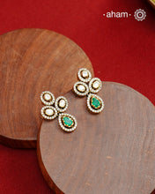 Expertly crafted earrings in 92.5% sterling silver with a fine gold polish finish, elegantly set with brilliant moissanite stones and a lustrous green stone in the center. Designed to offer lasting shine and sophistication making them a perfect choice for special occasions. &nbsp;