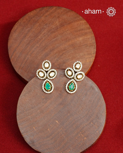 Expertly crafted earrings in 92.5% sterling silver with a fine gold polish finish, elegantly set with brilliant moissanite stones and a lustrous green stone in the center. Designed to offer lasting shine and sophistication making them a perfect choice for special occasions. 