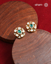 These expertly crafted studs feature 92.5% sterling silver with a fine gold polish finish, elegantly set with brilliant moissanite stones and a lustrous green stone in the center. Designed to offer lasting shine and sophistication making them a perfect choice for both everyday wear and special occasions.