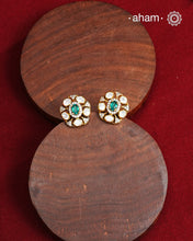 These expertly crafted studs feature 92.5% sterling silver with a fine gold polish finish, elegantly set with brilliant moissanite stones and a lustrous green stone in the center. Designed to offer lasting shine and sophistication making them a perfect choice for both everyday wear and special occasions.