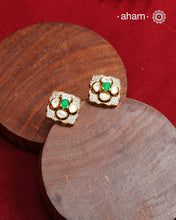 These expertly crafted studs feature 92.5% sterling silver with a fine gold polish finish, elegantly set with brilliant moissanite stones and a lustrous green stone in the center. Designed to offer lasting shine and sophistication making them a perfect choice for both everyday wear and special occasions.  