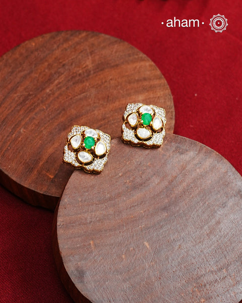 These expertly crafted studs feature 92.5% sterling silver with a fine gold polish finish, elegantly set with brilliant moissanite stones and a lustrous green stone in the center. Designed to offer lasting shine and sophistication making them a perfect choice for both everyday wear and special occasions.  