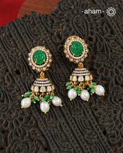 Thoughtfully crafted in 92.5 sterling silver with a fine gold polish, these jhumkies celebrate timeless design and fine craftsmanship. A luminous green stone takes center stage, framed by shimmering moissanites that catch the light beautifully. Refined, versatile, and easy to wear, they are designed to become a favourite for years to come.