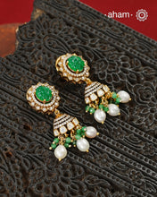 Thoughtfully crafted in 92.5 sterling silver with a fine gold polish, these jhumkies celebrate timeless design and fine craftsmanship. A luminous green stone takes center stage, framed by shimmering moissanites that catch the light beautifully. Refined, versatile, and easy to wear, they are designed to become a favourite for years to come.