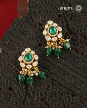 Thoughtfully crafted in 92.5 sterling silver with a fine gold polish, these studs celebrate timeless design and fine craftsmanship. A luminous green stone takes center stage, framed by shimmering moissanites that catch the light beautifully. Refined, versatile, and easy to wear, they are designed to become a favourite for years to come.