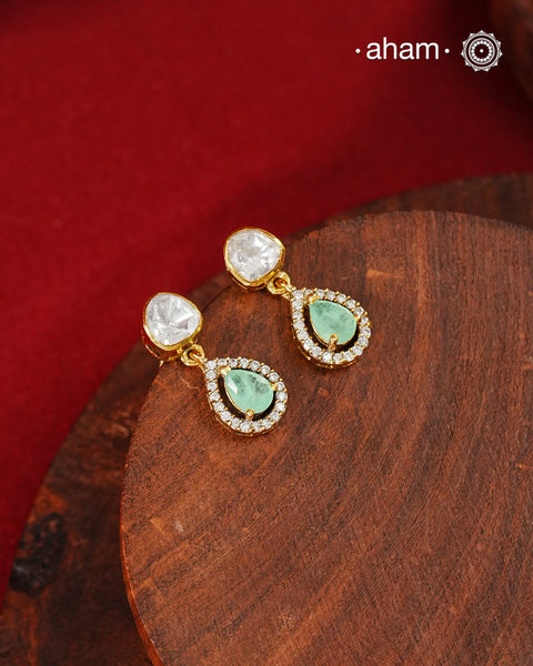 Expertly crafted studs in 92.5% sterling silver with a fine gold polish finish and elegantly set with brilliant moissanite stones and light green stone drop. Designed to offer lasting shine and sophistication making them a perfect choice for special occasions. &nbsp;