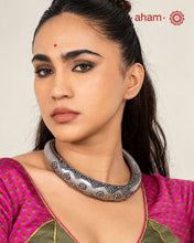 This exquisite hasli necklace showcases intricate fin rava work, meticulously crafted in 92.5% pure silver. Its detailed design highlights traditional craftsmanship, making it a timeless statement piece that enhances any ensemble with elegance and cultural richness. Ideal for those who appreciate expert artistry in silver jewellery.