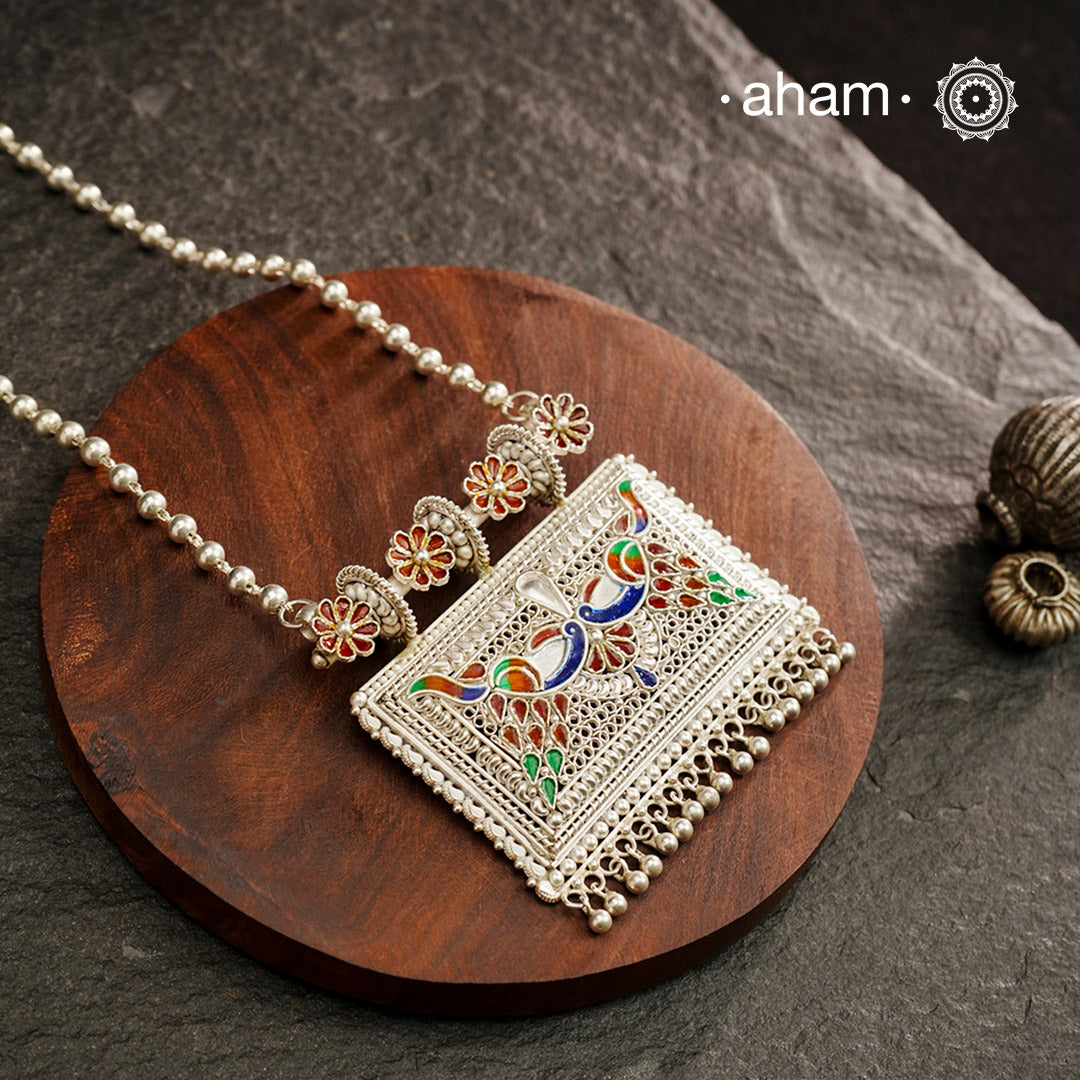 Crafted with traditional Rajasthani artistry, this Mewad Silver Peacock Neckpiece showcases exquisite meenawork and intricate peacock motifs. Each piece reflects centuries of heritage craftsmanship, making it an exceptional choice for connoisseurs of traditional jewelry. The authentic techniques employed create a statement piece that honours India's rich silversmithing legacy.
