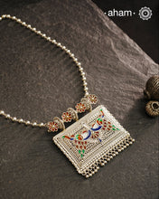 Crafted with traditional Rajasthani artistry, this Mewad Silver Peacock Neckpiece showcases exquisite meenawork and intricate peacock motifs. Each piece reflects centuries of heritage craftsmanship, making it an exceptional choice for connoisseurs of traditional jewelry. The authentic techniques employed create a statement piece that honours India's rich silversmithing legacy.