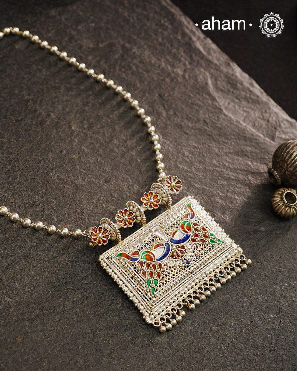 Crafted with traditional Rajasthani artistry, this Mewad Silver Peacock Neckpiece showcases exquisite meenawork and intricate peacock motifs. Each piece reflects centuries of heritage craftsmanship, making it an exceptional choice for connoisseurs of traditional jewelry. The authentic techniques employed create a statement piece that honours India's rich silversmithing legacy.