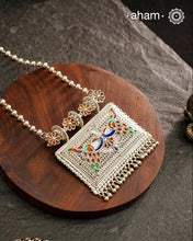 Crafted with traditional Rajasthani artistry, this Mewad Silver Peacock Neckpiece showcases exquisite meenawork and intricate peacock motifs. Each piece reflects centuries of heritage craftsmanship, making it an exceptional choice for connoisseurs of traditional jewelry. The authentic techniques employed create a statement piece that honours India's rich silversmithing legacy.