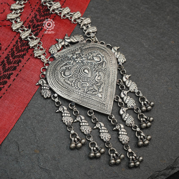 Enhance your style and make a statement with the Mewad Peacock Silver Neckpiece. Made from 92.5 silver, this intricately designed necklace showcases stunning peacock patterns. Pair it with your traditional kurta or any Indian attire to elevate your look.