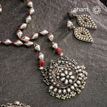 The Mewad Silver Neckpiece exemplifies superior craftsmanship with its intricate pendant design featuring a refined pearl setting. Meticulously crafted from 92.5 sterling silver, this piece combines traditional artistry with the distinctive texture of a dholki bead chain. The pendant's detailed silverwork demonstrates exceptional technical precision, creating a sophisticated adornment that honours traditional metalsmithing techniques while offering contemporary elegance.