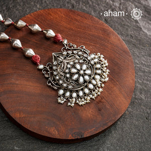 The Mewad Silver Neckpiece exemplifies superior craftsmanship with its intricate pendant design featuring a refined pearl setting. Meticulously crafted from 92.5 sterling silver, this piece combines traditional artistry with the distinctive texture of a dholki bead chain. The pendant's detailed silverwork demonstrates exceptional technical precision, creating a sophisticated adornment that honours traditional metalsmithing techniques while offering contemporary elegance.