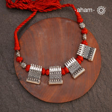 Crafted in 92.5 silver, this beautiful Mewad silver neckpiece features intricate rava and tar work. Its adjustable deep red thread allows for versatile wear, sitting comfortably below the neck. Enhance your attire with this elegant and unique piece.