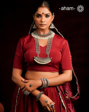 The Mewad Silver Neckpiece is a captivating accessory featuring a boat-shaped amulet delicately adorned with tiny pearls. Crafted from 92.5% pure silver, its side chains are embellished with elegant vintage-style flowers. This statement piece blends classic charm with subtle sophistication, making it the perfect addition to elevate your style effortlessly.