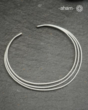 Discover understated elegance with this three-line twisted silver hasli, a masterfully crafted collar piece in 92.5 sterling silver. Its clean, geometric design bridges the gap between casual and formal wear—pair it effortlessly with your favourite shirt or dress. The versatile open framework welcomes customization; add a pendant to create a signature look or wear it bare for refined minimalism. Handcrafted with precision, this is a timeless piece you would love to wear.