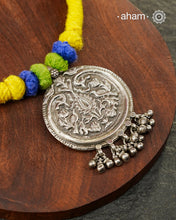 Show off your unique style with the Mewad Silver Neckpiece. A light weight pendant at the center with coloured thread, this neckpiece is sure to add a pop of colour to any outfit. Elevate your look and stand out from the crowd with this beautiful neckpiece.