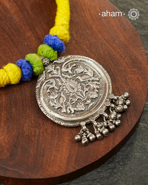 Show off your unique style with the Mewad Silver Neckpiece. A light weight pendant at the center with coloured thread, this neckpiece is sure to add a pop of colour to any outfit. Elevate your look and stand out from the crowd with this beautiful neckpiece.