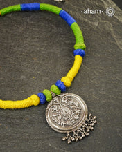 Show off your unique style with the Mewad Silver Neckpiece. A light weight pendant at the center with coloured thread, this neckpiece is sure to add a pop of colour to any outfit. Elevate your look and stand out from the crowd with this beautiful neckpiece.
