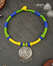 Show off your unique style with the Mewad Silver Neckpiece. A light weight pendant at the center with coloured thread, this neckpiece is sure to add a pop of colour to any outfit. Elevate your look and stand out from the crowd with this beautiful neckpiece.