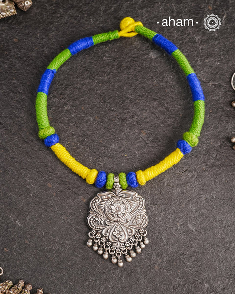 Show off your unique style with the Mewad Silver Neckpiece. A light weight pendant at the center with coloured thread, this neckpiece is sure to add a pop of colour to any outfit. Elevate your look and stand out from the crowd with this beautiful neckpiece.