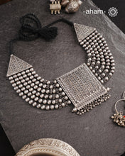 This expert-crafted Mewad Silver Neckpiece features a striking central pendant flanked by side triangles, all detailed with fine tar work. Its bold design makes it an exceptional statement piece, perfect for elevating any outfit with a touch of traditional artistry and refined craftsmanship.