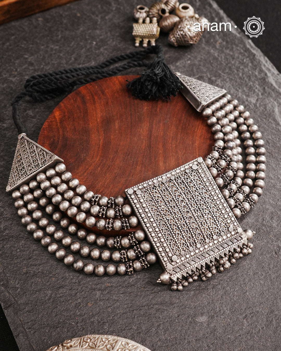 This expert-crafted Mewad Silver Neckpiece features a striking central pendant flanked by side triangles, all detailed with fine tar work. Its bold design makes it an exceptional statement piece, perfect for elevating any outfit with a touch of traditional artistry and refined craftsmanship.