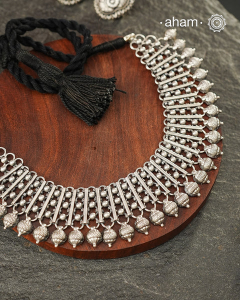 Crafted in 92.5 sterling silver, this handcrafted neckpiece showcases a beautifully balanced composition of ribbed silver bars, delicate ravawork, and intricately textured silver drops. Every element is thoughtfully arranged to create a striking silhouette that reflects the beauty of traditional craftsmanship.

Despite its statement appeal, the neckpiece is lightweight and comfortable to wear, making it an effortless choice for festive celebrations, intimate gatherings, or elevating everyday dressing. 