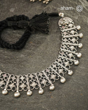 Graceful and intricately detailed, this handcrafted silver neckpiece crafted in 92.5 silver is designed to make a statement through its beautifully balanced composition. Delicate openwork, sculpted floral accents, and polished silver drops come together in a rhythmic pattern that lends the piece depth, texture, and movement.

Despite its striking appearance, the neckpiece is lightweight and comfortable to wear, making it an effortless choice for both everyday dressing and special occasions. 