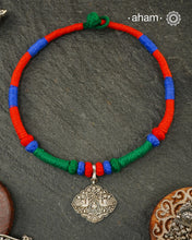 Show off your unique style with the Mewad Silver Neckpiece. A light weight pendant at the center with coloured thread, this neckpiece is sure to add a pop of colour to any outfit. Elevate your look and stand out from the crowd with this beautiful neckpiece.