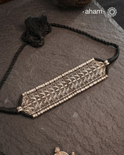This Tribal Lotus Silver Choker exemplifies the refined craftsmanship of Orissa, skillfully handcrafted in pure silver. Featuring a stunning lotus motif, it embodies traditional artistry with a contemporary appeal. Perfect for those who value expert design and cultural heritage, this choker enhances any outfit with its elegant and distinctive presence.