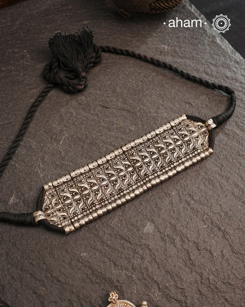 This Tribal Lotus Silver Choker exemplifies the refined craftsmanship of Orissa, skillfully handcrafted in pure silver. Featuring a stunning lotus motif, it embodies traditional artistry with a contemporary appeal. Perfect for those who value expert design and cultural heritage, this choker enhances any outfit with its elegant and distinctive presence.