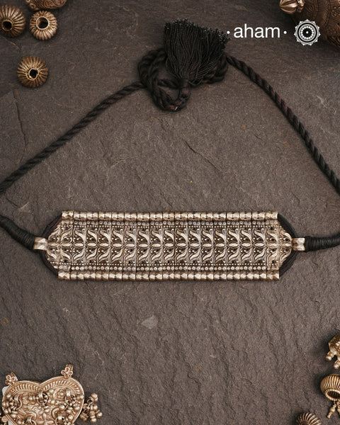 This Tribal Lotus Silver Choker exemplifies the refined craftsmanship of Orissa, skillfully handcrafted in pure silver. Featuring a stunning lotus motif, it embodies traditional artistry with a contemporary appeal. Perfect for those who value expert design and cultural heritage, this choker enhances any outfit with its elegant and distinctive presence.