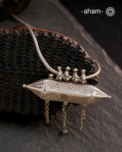 This Vintage Amulet Silver Neckpiece showcases authentic tribal craftsmanship from South India, reflecting rich cultural heritage. Handcrafted in sterling silver, it features intricate detailing that embodies traditional design elements. Perfect for collectors and connoisseurs, this piece adds a unique, timeless accent to any ensemble while honoring artisanal legacy.