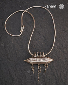 This Vintage Amulet Silver Neckpiece showcases authentic tribal craftsmanship from South India, reflecting rich cultural heritage. Handcrafted in sterling silver, it features intricate detailing that embodies traditional design elements. Perfect for collectors and connoisseurs, this piece adds a unique, timeless accent to any ensemble while honoring artisanal legacy.