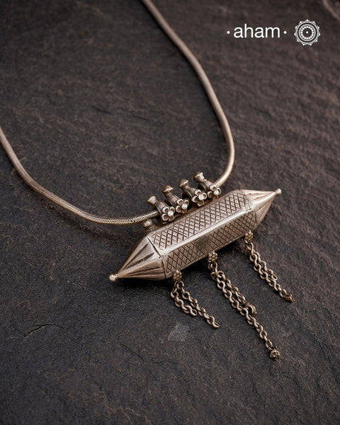 This Vintage Amulet Silver Neckpiece showcases authentic tribal craftsmanship from South India, reflecting rich cultural heritage. Handcrafted in sterling silver, it features intricate detailing that embodies traditional design elements. Perfect for collectors and connoisseurs, this piece adds a unique, timeless accent to any ensemble while honoring artisanal legacy.