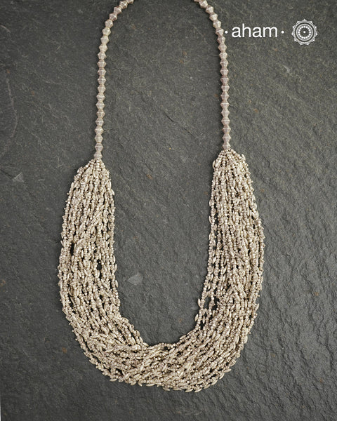 The Odhisa Dhaan Sarson Mala is a masterful vintage creation that embodies both heritage and symbolism.

Featuring multiple strands of delicately crafted rice- (Dhaan) and mustard- (Sarson) shaped silver beads, this neckpiece reflects the cultural traditions of the Kutia Kondh tribals of Odisha, for whom these forms represent prosperity, fertility, and abundance.