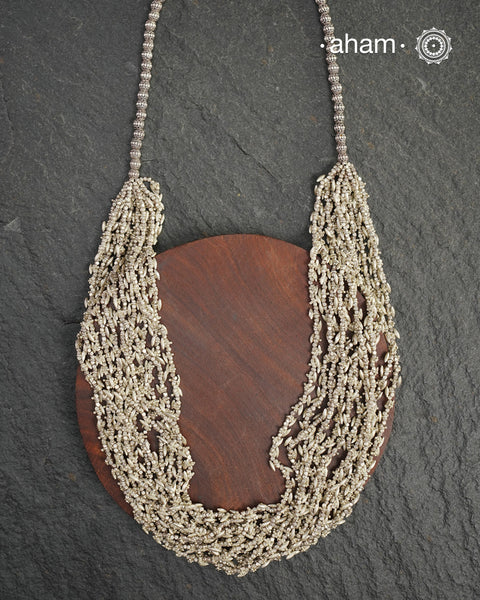 The Odhisa Dhaan Sarson Mala is a masterful vintage creation that embodies both heritage and symbolism.

Featuring multiple strands of delicately crafted rice- (Dhaan) and mustard- (Sarson) shaped silver beads, this neckpiece reflects the cultural traditions of the Kutia Kondh tribals of Odisha, for whom these forms represent prosperity, fertility, and abundance.