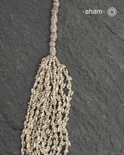 The Odhisa Dhaan Sarson Mala is a masterful vintage creation that embodies both heritage and symbolism.

Featuring multiple strands of delicately crafted rice- (Dhaan) and mustard- (Sarson) shaped silver beads, this neckpiece reflects the cultural traditions of the Kutia Kondh tribals of Odisha, for whom these forms represent prosperity, fertility, and abundance.