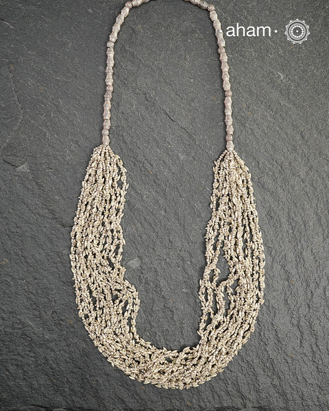 The Odhisa Dhaan Sarson Mala is a masterful vintage creation that embodies both heritage and symbolism.

Featuring multiple strands of delicately crafted rice- (Dhaan) and mustard- (Sarson) shaped silver beads, this neckpiece reflects the cultural traditions of the Kutia Kondh tribals of Odisha, for whom these forms represent prosperity, fertility, and abundance.