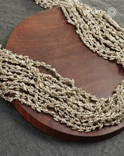 The Odhisa Dhaan Sarson Mala is a masterful vintage creation that embodies both heritage and symbolism.

Featuring multiple strands of delicately crafted rice- (Dhaan) and mustard- (Sarson) shaped silver beads, this neckpiece reflects the cultural traditions of the Kutia Kondh tribals of Odisha, for whom these forms represent prosperity, fertility, and abundance.