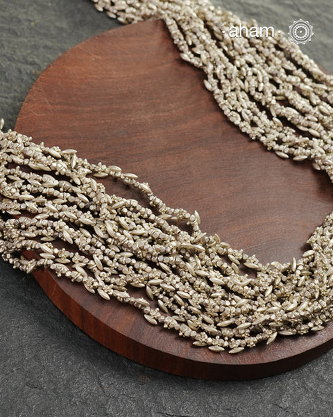 The Odhisa Dhaan Sarson Mala is a masterful vintage creation that embodies both heritage and symbolism.

Featuring multiple strands of delicately crafted rice- (Dhaan) and mustard- (Sarson) shaped silver beads, this neckpiece reflects the cultural traditions of the Kutia Kondh tribals of Odisha, for whom these forms represent prosperity, fertility, and abundance.