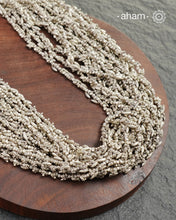 The Odhisa Dhaan Sarson Mala is a masterful vintage creation that embodies both heritage and symbolism.

Featuring multiple strands of delicately crafted rice- (Dhaan) and mustard- (Sarson) shaped silver beads, this neckpiece reflects the cultural traditions of the Kutia Kondh tribals of Odisha, for whom these forms represent prosperity, fertility, and abundance.