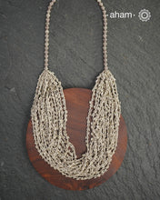 The Odhisa Dhaan Sarson Mala is a masterful vintage creation that embodies both heritage and symbolism.

Featuring multiple strands of delicately crafted rice- (Dhaan) and mustard- (Sarson) shaped silver beads, this neckpiece reflects the cultural traditions of the Kutia Kondh tribals of Odisha, for whom these forms represent prosperity, fertility, and abundance.