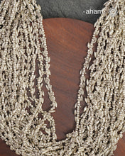 The Odhisa Dhaan Sarson Mala is a masterful vintage creation that embodies both heritage and symbolism.

Featuring multiple strands of delicately crafted rice- (Dhaan) and mustard- (Sarson) shaped silver beads, this neckpiece reflects the cultural traditions of the Kutia Kondh tribals of Odisha, for whom these forms represent prosperity, fertility, and abundance.