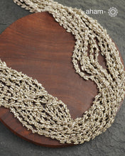 The Odhisa Dhaan Sarson Mala is a masterful vintage creation that embodies both heritage and symbolism.

Featuring multiple strands of delicately crafted rice- (Dhaan) and mustard- (Sarson) shaped silver beads, this neckpiece reflects the cultural traditions of the Kutia Kondh tribals of Odisha, for whom these forms represent prosperity, fertility, and abundance.